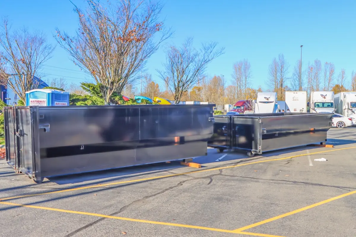 Professional dumpster rental service with roll-off container on residential driveway in Madera Acres